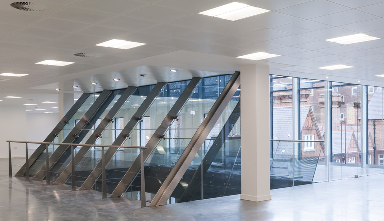 View from the top floor of a modern office building towards lift assembly